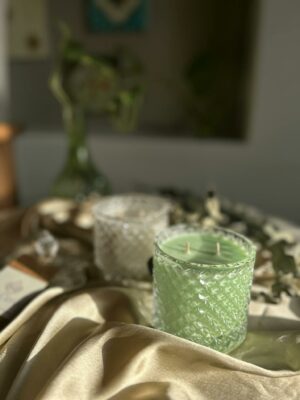 Close-up of a White and Green Candles in Jars